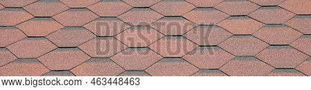 Reddish And Faded Surface. View Of Bituminous Or Composite Shingles On The Roof Of A Building. Figur