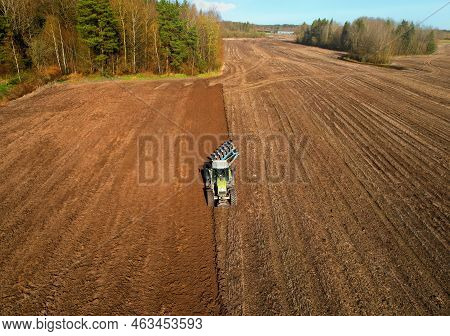 Tractor With Cultivator Plowing Field. Tractor Disk Harrow On Ploughing A Soil. Sowing Seed On Plowe