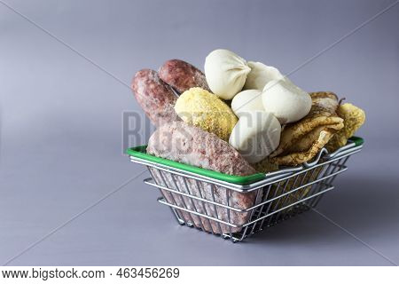 Basket With Semi-finished Products On A Dark Gray Background. Food For Quick Cooking.