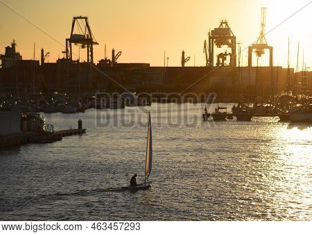 Sailboat On Sunset In Harbour. Sailing On Sea On Sailboat On The Waves. Yachtsman During Training On