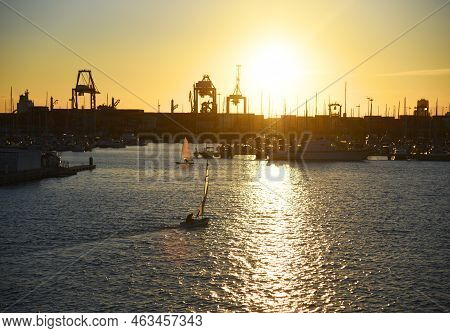 Sailboat On Sunset In Harbour. Sailing On Sea On Sailboat On The Waves. Yachtsman During Training On