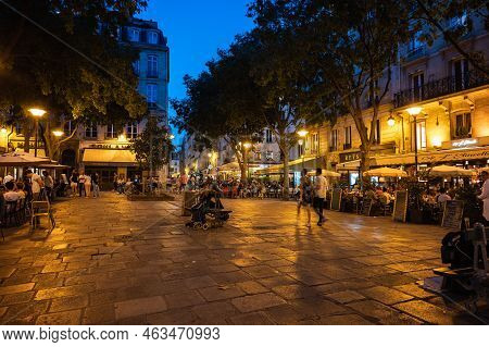Paris, France - August 27 2022: People Walking And Dining In Cafe In The Evening In Famous The Marai