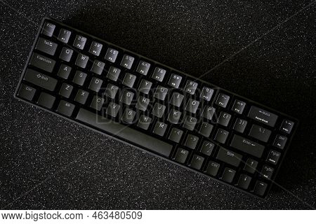 Black Mechanical Gaming Computer Keyboard On A Sparkling Dark Background. Small Wireless Keyboard Wi