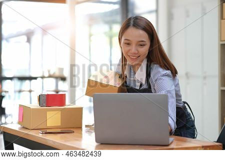 Portrait Of Asian Young Woman Sme Working With A Box At Home The Workplace.start-up Small Business O