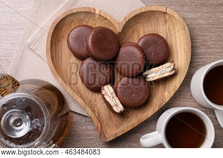 Tasty Choco Pies And Tea On Wooden Table, Flat Lay