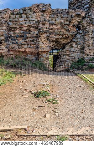 Interior Stone And Brick Wall Of Castle Ruins With Opening For Egress.