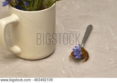 A Spoon With Chicory Flower And Chicory Powder And Chicory Flowers In A Coffee Mug