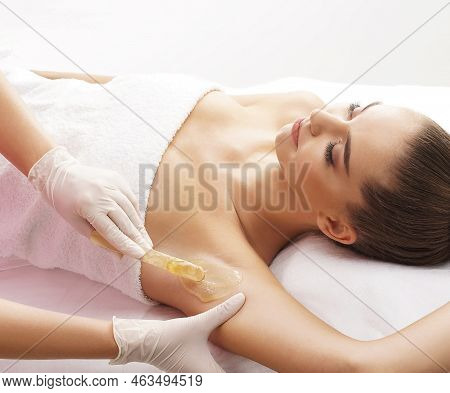 Hair Removal, Beauty And Health Concept. A Young Girl Is Getting An Epilation Procedure. A Processio