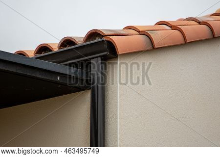 Modern Dark Black Roof Gutter And Drain Pipe With Copy Space