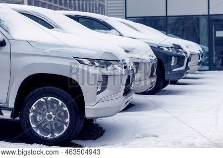 Snow-covered Cars In The City In The Parking Lot. Stopping The Movement Of Cars Due To Bad Weather