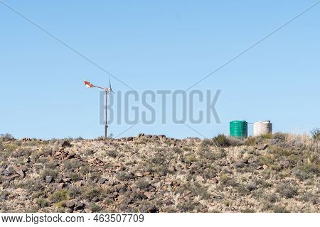 A Landscape, With A Wind Generator And Two Water Tanks On A Hill On The Road Between Loxton And Fras