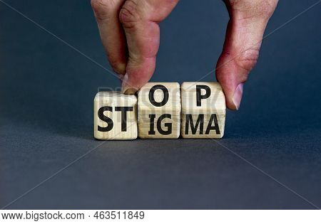 Stop Stigma Symbol. Concept Words Stop Stigma On Wooden Cubes. Businessman Hand. Beautiful Grey Tabl