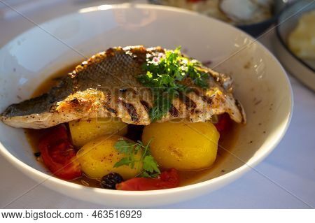 Provence Cuisine, Filet Of Seabass White Fish Served With Potatoes, Tomatoes And .bouillabaisse Jus