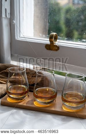 Flight Of Single Malt Scotch Whisky Served On Old Wooden Window Sill In Scottisch House In Edinburgh
