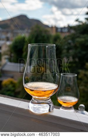 Glass Of Single Malt Scotch Whisky Served On Old Window Sill In Scottisch House With View On Old Par