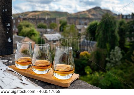 Flight Of Single Malt Scotch Whisky Served On Old Window Sill In Scottisch House With View On Old Pa