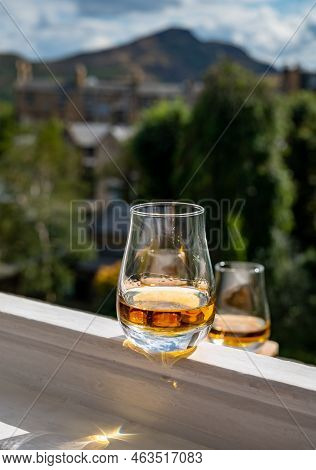 Glass Of Single Malt Scotch Whisky Served On Old White Window Sill In Scottisch House With View On O