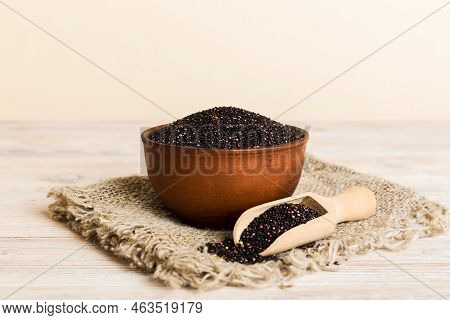 Quinoa Seeds In Bowl And Spoon On Colored Background. Healthy Kinwa In Small Bowl. Healthy Superfood