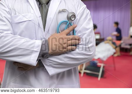 Doctor In Gown Uniform With Stethoscope Standing And Fold His Arms Over The Chest In Blood Donor Roo