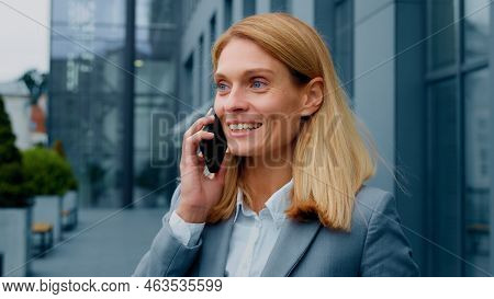 Happy Enthusiastic Excited Woman Talking On Mobile Phone Outdoors Sharing Good Experience With Frien