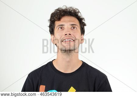 Amused Man In T-shirt With Letters Looking Up