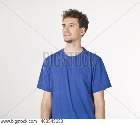 Cut Out Portrait Of Young Guy In Blue T-shirt Looking To The Right
