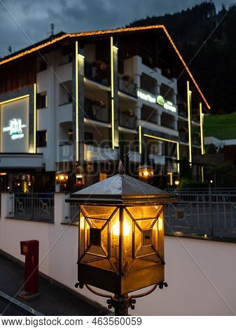 Ischgl, Austria - July 25, 2022: Night Scenery Of A Street Lantern And A Hotel In Ischgl In Backgrou
