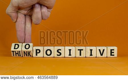 Think And Do Positive Symbol. Businessman Turns Wooden Cubes And Changes Words Think Positive To Do 