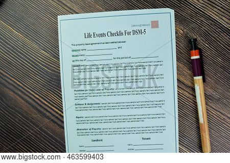 Financing Concept Of Life Events Checklist For Dsm-5 Write On Paperwork Isolated On Wooden Table.
