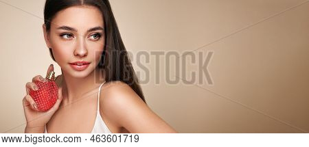Young Beautiful Woman With A Bottle Of Perfume. Model With Healthy Skin, Close Up Portrait. Cosmetol