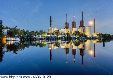 A Combined Heat And Power Plant In Berlin At Night With A Perfect Reflection In The Water