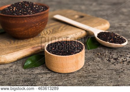 Quinoa Seeds In Bowl And Spoon On Colored Background. Healthy Kinwa In Small Bowl. Healthy Superfood