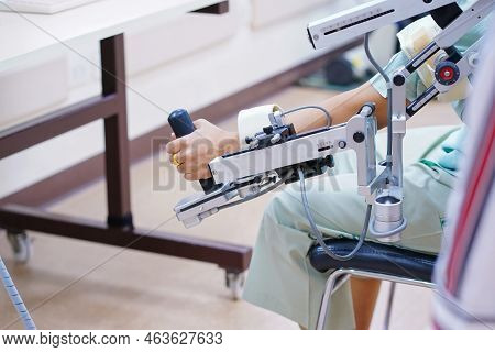 Woman Wear Machine Arm For Physical Therapy. By Defining How A Robot Driven Moving Technique Can Be