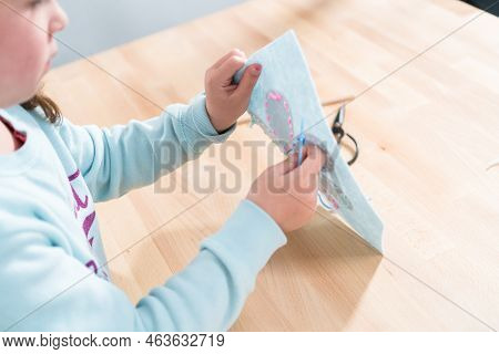 Little Girl Learning How To Sew With Sewing Craft Kit For Kids.