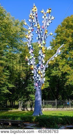 Many Multi-coloured Birdhouses On Different Levels Attached To A Wooden Pole. The Concept Is A Multi
