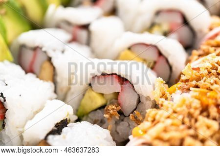 Pre-packaged Variety Of Sushi And Sushi Rolls In A Plastic Tray.