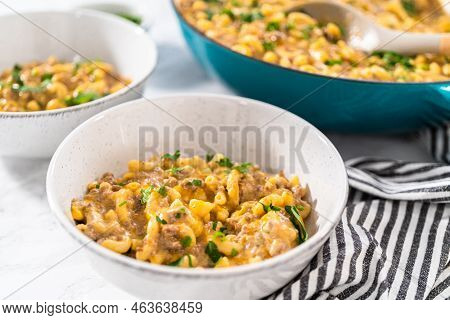 Serving Homemade Hamburger Helper In White Ceramic Bowls.
