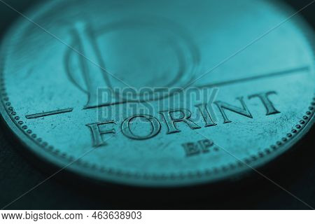 Hungarian Coin Of 10 Forints Lies On Dark Surface Closeup. Money Of Hungary. News About Economy Or C