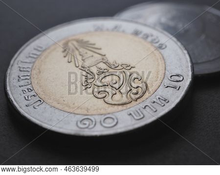 Translation: 10 Baht Thailand. Thai Coin Light Background. News About Money Or Currency. Loan And Cr