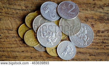Various Old Lithuanian Coins Isolated On Wooden Background.