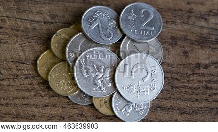 Various Old Lithuanian Coins Isolated On Wooden Background