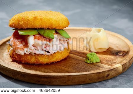 Pan-asian Cuisine Concept. Japanese Sushi Burger Made From Rice Bread, Crab Meat, Avokado And Wasabi