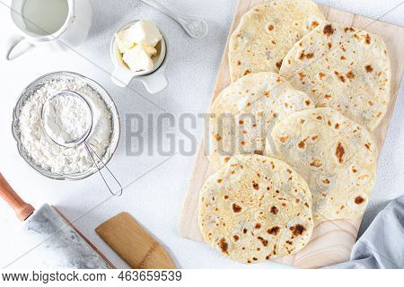 Homemade Wheat Tortillas, Pita Bread, Tortilla, Pita With Ingredients For Cooking On A White Table. 