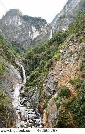 Vertical Shot Of A River Flowing Through Rocks In Xiulin, Hualien, Taiwan