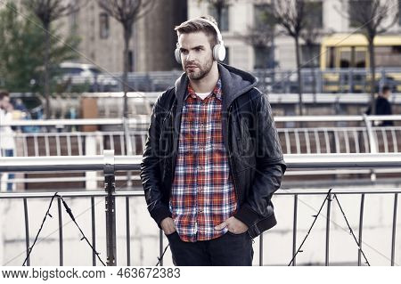Deliver Perfect Audio Reproduction. Young Man Wear Audio Headphones Outdoor. Handsome Guy Listen To 