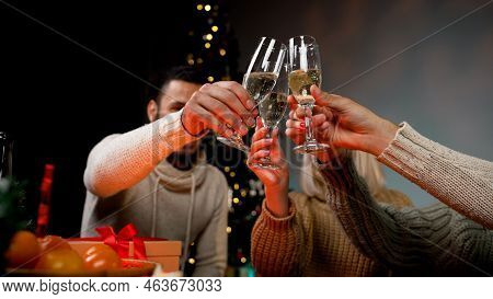 Champagne Glasses On The Background Of The Christmas Tree. Friends Celebrate The New Year With Champ