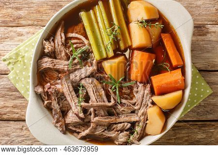 Roast Pot Of Slow Cooked Beef With Vegetables In A Spicy Sauce Close-up In A Frying Pan On The Table