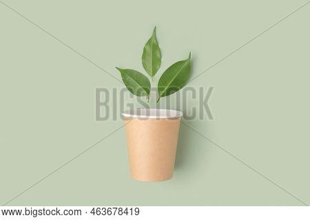 Eco - Friendly Tableware On Green Background. Top View. Plastic Free Set Of Brown Paper Utensil. Str
