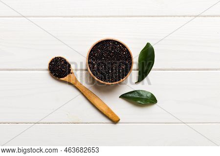 Quinoa Seeds In Bowl And Spoon On Colored Background. Healthy Kinwa In Small Bowl. Healthy Superfood