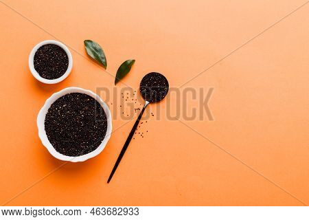 Quinoa Seeds In Bowl And Spoon On Colored Background. Healthy Kinwa In Small Bowl. Healthy Superfood